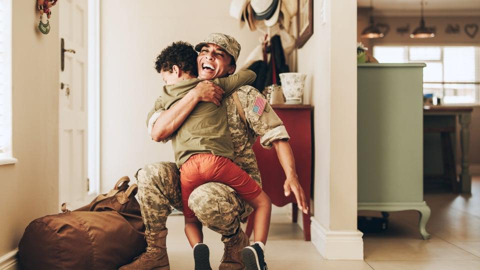 Military dad coming home from service hugging his child